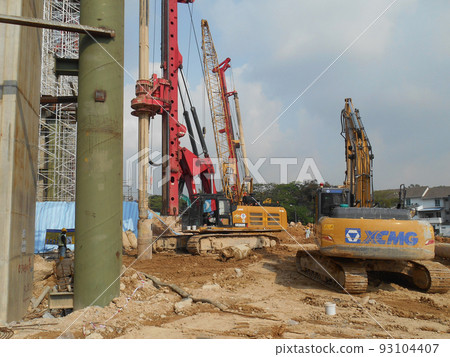 KUALA LUMPUR, MALAYSIA -MARCH 30, 2022: Bore pile rig machine at the construction site. The machine used to driven pile for building foundation work. Operated by skilled workers. KUALA LUMPUR, MALAYSIA -MARCH 30, 2022: Bore pile rig machine at the construction site. The machine used to driven pile for building foundation work. Operated by skilled workers. 93104407