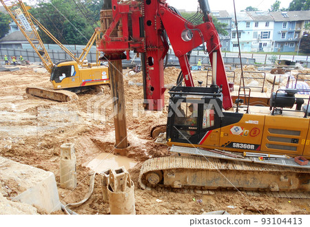 KUALA LUMPUR, MALAYSIA -MARCH 30, 2022: Bore pile rig machine at the construction site. The machine used to driven pile for building foundation work. Operated by skilled workers. KUALA LUMPUR, MALAYSIA -MARCH 30, 2022: Bore pile rig machine at the construction site. The machine used to driven pile for building foundation work. Operated by skilled workers. 93104413