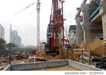 KUALA LUMPUR, MALAYSIA -MARCH 30, 2022: Bore pile rig machine at the construction site. The machine used to driven pile for building foundation work. Operated by skilled workers. KUALA LUMPUR, MALAYSIA -MARCH 30, 2022: Bore pile rig machine at the construction site. The machine used to driven pile for building foundation work. Operated by skilled workers. 93104415