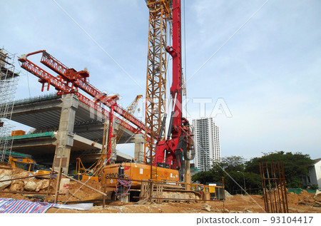 KUALA LUMPUR, MALAYSIA -MARCH 30, 2022: Bore pile rig machine at the construction site. The machine used to driven pile for building foundation work. Operated by skilled workers. KUALA LUMPUR, MALAYSIA -MARCH 30, 2022: Bore pile rig machine at the construction site. The machine used to driven pile for building foundation work. Operated by skilled workers. 93104417