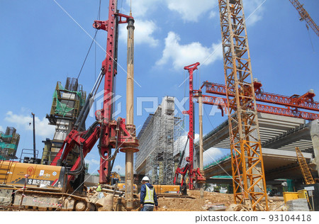 KUALA LUMPUR, MALAYSIA -MARCH 30, 2022: Bore pile rig machine at the construction site. The machine used to driven pile for building foundation work. Operated by skilled workers. KUALA LUMPUR, MALAYSIA -MARCH 30, 2022: Bore pile rig machine at the construction site. The machine used to driven pile for building foundation work. Operated by skilled workers. 93104418