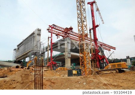 KUALA LUMPUR, MALAYSIA -MARCH 30, 2022: Bore pile rig machine at the construction site. The machine used to driven pile for building foundation work. Operated by skilled workers.  93104419