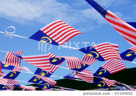 SELANGOR, MALAYSIA -AUGUST 31, 2021: Several small Malaysian flags are tied together and installed horizontally. These flags flutter when the wind blows. SELANGOR, MALAYSIA -AUGUST 31, 2021: Several small Malaysian flags are tied together and installed horizontally. These flags flutter when the wind blows. 93104692