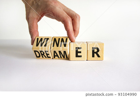 Winner or dreamer symbol. Concept words Winner or dreamer on wooden cubes. Businessman hand. Beautiful white table white background. Business and Winner or dreamer concept. Copy space. 93104990