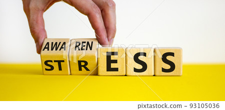 Stress awareness symbol. Businessman turns cubes and changes the word 'stress' to 'awareness'. Beautiful white background. Business, psychological and stress awareness concept. Copy space. Stress awareness symbol. Businessman turns cubes and changes the word 'stress' to 'awareness'. Beautiful white background. Business, psychological and stress awareness concept. Copy space. 93105036