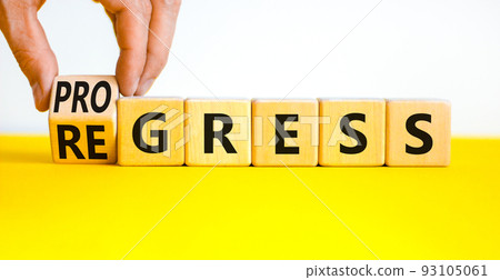 Regress or progress symbol. Businessman turns wooden cubes and changes the word Regress to Progress. Beautiful yellow table white background. Business regress or progress concept. Copy space. Regress or progress symbol. Businessman turns wooden cubes and changes the word Regress to Progress. Beautiful yellow table white background. Business regress or progress concept. Copy space. 93105061
