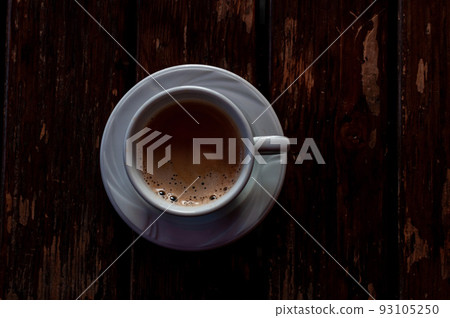 A cup with coffee on a table A cup with coffee on a table 93105250
