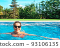 mature woman swimming happily in the pool at home on summer holidays. business woman swimming in her free time. holiday and travel concept. 93106135