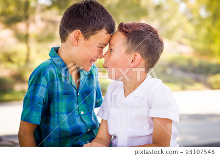 Outdoor portrait of mixed race Chinese and Caucasian brothers having fun. Outdoor portrait of mixed race Chinese and Caucasian brothers having fun. 93107548