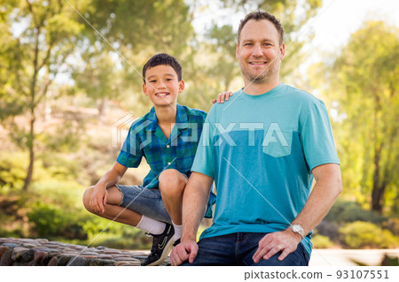 Outdoor portrait of mixed race Chinese and Caucasian father and son. 93107551