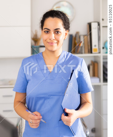 Woman is standing with documents in clinic Woman is standing with documents in clinic 93110025