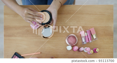 Woman using cosmetic and try to make up following her vlogger 93113700