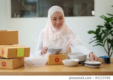 Asian small business owner working at home office. Business retail market and online sell marketing delivery, SME e-commerce concept. Asian small business owner working at home office. Business retail market and online sell marketing delivery, SME e-commerce concept. 93113706