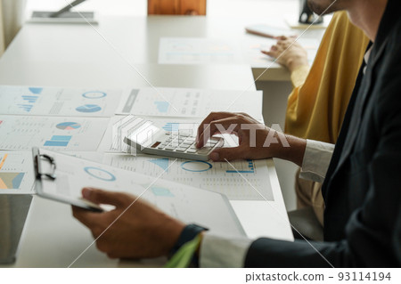 Administration or Accountant discussing with partner are meeting to audit finance planning sales to meet targets set in next year. Finance concept 93114194