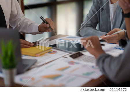 Administration or Accountant discussing with partner are meeting to audit finance planning sales to meet targets set in next year. Finance concept. Administration or Accountant discussing with partner are meeting to audit finance planning sales to meet targets set in next year. Finance concept. 93114372
