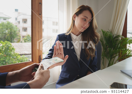 Woman Rejecting the contractor's offer of black money in exchange for a permit in the deal. Concepts of corruption and anti bribery. 93114427