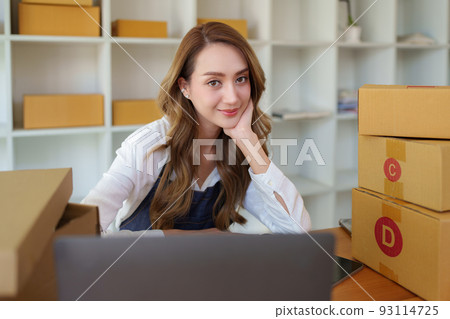 Attractive Asian SME business woman checking order at warehouse. Attractive Asian SME business woman checking order at warehouse. 93114725