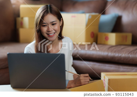 Image of Young asian woman startup freelance with parcel box and talking with customer by computer laptop. Online marketing packing box delivery concept. 93115043