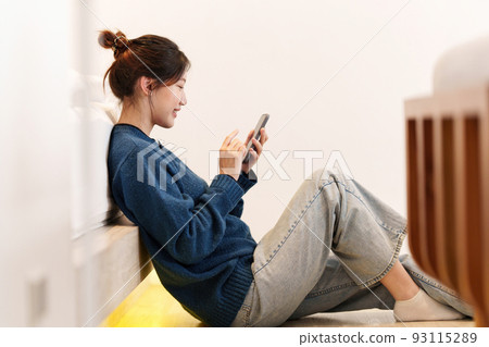 Portrait of Young Asian woman chatting with her friend and checking social media by smartphone. Lifestyle concept. 93115289