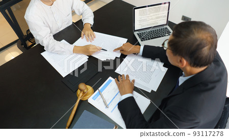 Lawyer and legal concept, Senior lawyer pointing to contract while explaining detail to businessman 93117278