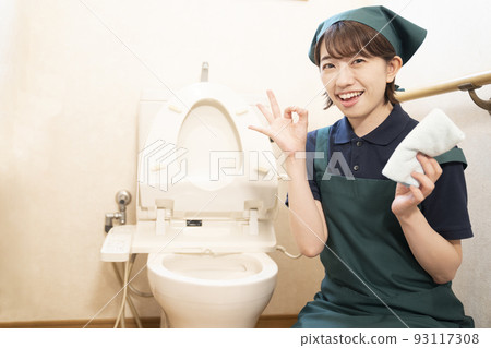 House cleaning woman cleaning the toilet and giving an okay sign House cleaning woman cleaning the toilet and giving an okay sign 93117308