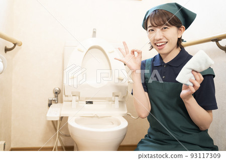 House cleaning woman cleaning the toilet and giving an okay sign House cleaning woman cleaning the toilet and giving an okay sign 93117309