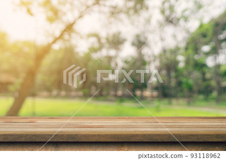 Empty wooden table top and green bokeh display montage for product with space. Empty wooden table top and green bokeh display montage for product with space. 93118962