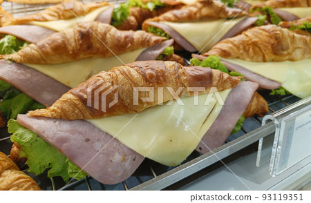 Closeup view. Croissant with ham and cheese on tray. Closeup view. Croissant with ham and cheese on tray. 93119351