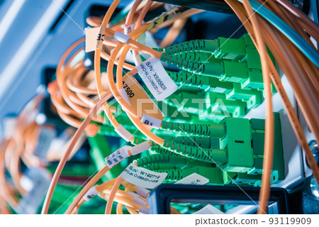 detail of server rack with fiber optic cables attached to front panel switch ports detail of server rack with fiber optic cables attached to front panel switch ports 93119909