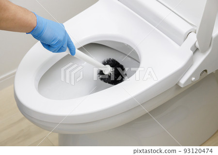 Cleaning the toilet with a brush Cleaning the toilet with a brush 93120474