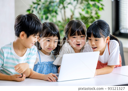 Elementary school student touching a computer Elementary school student touching a computer 93121327