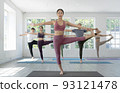 Asian yoga trainer and her student pose yoga basic position in her class room 93121478