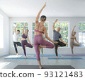 Asian yoga trainer and her student pose yoga basic position in her class room 93121483