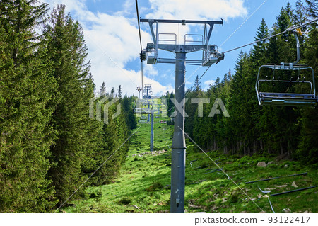 Beautiful mountains, covered with forest and open cable car line. Karpacz resort in Poland with lift road. Family outdoor recreation in mountains 93122417