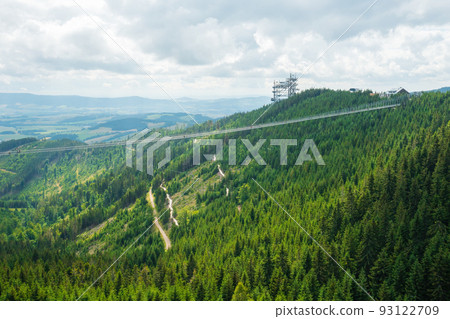 Sky Bridge 721 is the longest suspension bridge between two hills in the forest, Dolni Morava, Czech Republic . One way footbridge in touristic place in the forest in summer. Sky Bridge 721 is the longest suspension bridge between two hills in the forest, Dolni Morava, Czech Republic . One way footbridge in touristic place in the forest in summer. 93122709