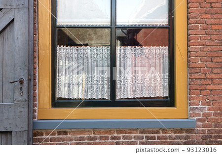Window of cozy house with vintage curtains Window of cozy house with vintage curtains 93123016