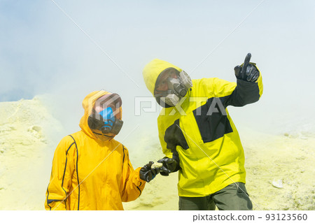 volcano scientists on the slope of the volcano collect samples of minerals against the backdrop of smoking sulfur fumaroles volcano scientists on the slope of the volcano collect samples of minerals against the backdrop of smoking sulfur fumaroles 93123560
