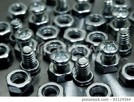 Threaded connection. Bolts and nuts on aluminum surface macro shot 93124564