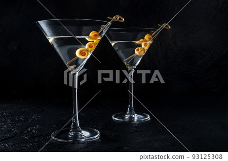Martini, two glasses with spicy olives, on a black background 93125308
