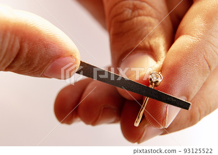 Working process. Closeup hands of jeweler at work in jewelry. Desktop for craft jewelry making with professional tools. Working process. Closeup hands of jeweler at work in jewelry. Desktop for craft jewelry making with professional tools. 93125522