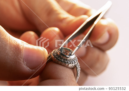 Working process. Closeup hands of jeweler at work in jewelry. Desktop for craft jewelry making with professional tools. Working process. Closeup hands of jeweler at work in jewelry. Desktop for craft jewelry making with professional tools. 93125532