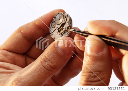 Closeup watchmaker's hands repairing mechanical watches isolated over white background. Concept of vintage retro mechanisms, job, work, ad 93125551