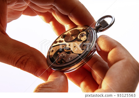 Closeup watchmaker's hands repairing mechanical watches isolated over white background. Concept of vintage retro mechanisms, job, work, ad Closeup watchmaker's hands repairing mechanical watches isolated over white background. Concept of vintage retro mechanisms, job, work, ad 93125563