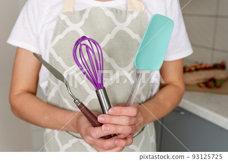 Portrait of confectioner woman in apron preparing to cook. 93125725