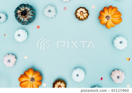 Trendy bright colorful Halloween background with border of orange, green, white, golden pumpkins on turquoise layout. Autumn, fall, halloween, thanksgiving day concept. Flat lay, top view, copy space Trendy bright colorful Halloween background with border of orange, green, white, golden pumpkins on turquoise layout. Autumn, fall, halloween, thanksgiving day concept. Flat lay, top view, copy space 93125960