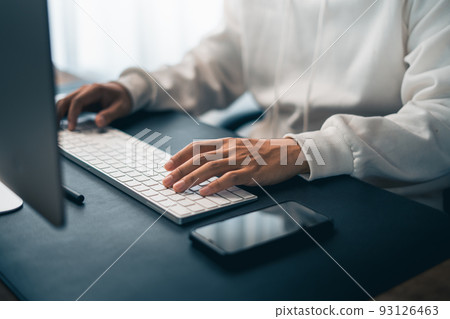 Man working on computer desk at home office 93126463