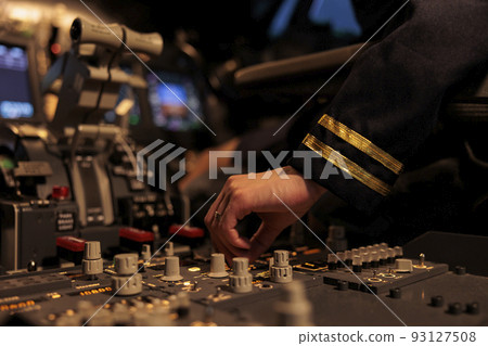 Woman copilot using control panel command on dashboard navigation to fly ariplane in cockpit. Female airliner flying plane in cabin with power engine and switch lever. Close up. 93127508