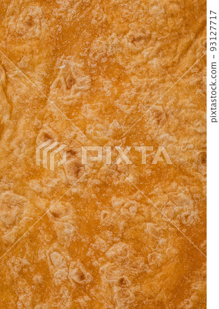 Tomato flavored wheat tortilla wraps. Spanish or Mexican circular unleavened flatbread from wheat flour. Ingredient for cooking fast food or snack. Closeup, texture background 93127717