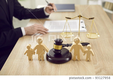 Figures of family are separated by judge's gavel, which symbolizes divorce case and custody of child Figures of family are separated by judge's gavel, which symbolizes divorce case and custody of child 93127958