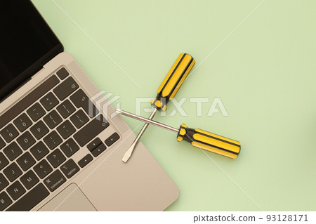 computer repair, laptop and screwdrivers on green background computer repair, laptop and screwdrivers on green background 93128171